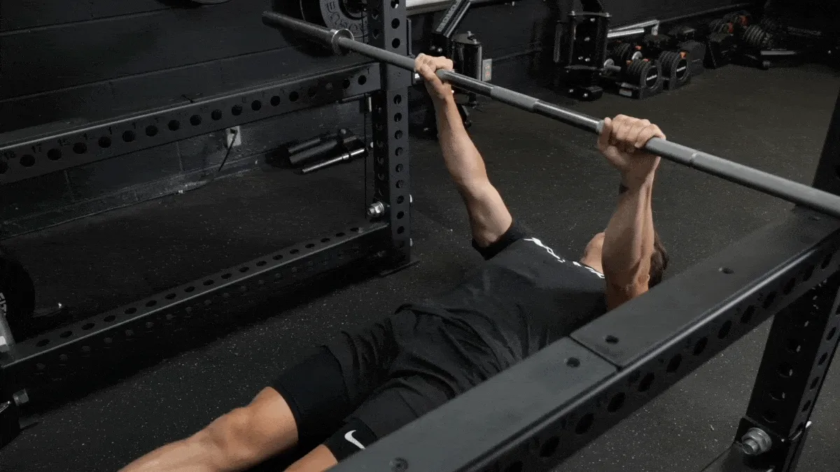 A person performing the inverted row exercise.