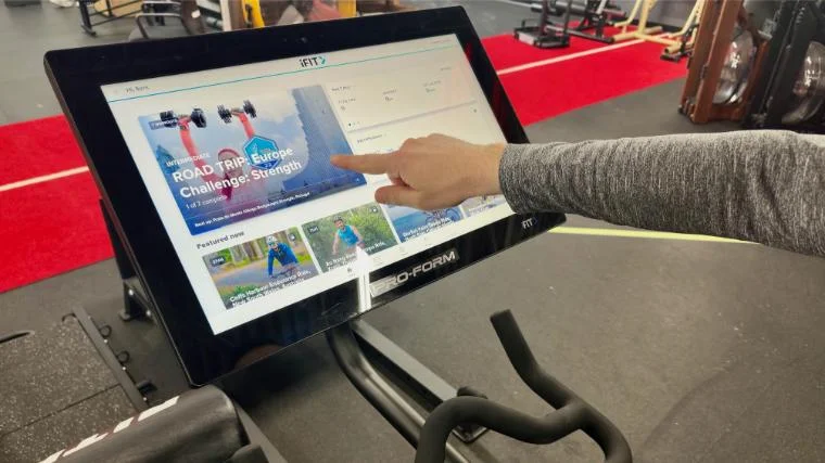 BarBend reviews writer Matt Cummings selecting an iFIT class on the ProForm Pro Studio Bike Pro 22.
