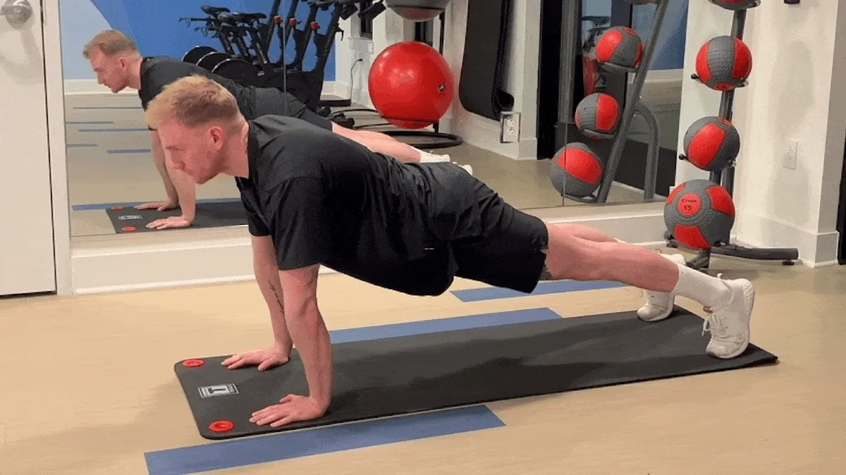 A person performing mountain climbers.