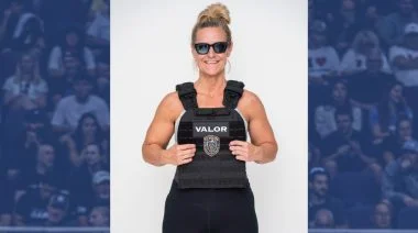 Jenn Powers wearing a swat-style vest