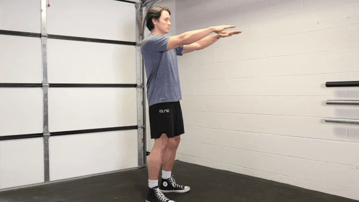 A person doing the bodyweight squat.