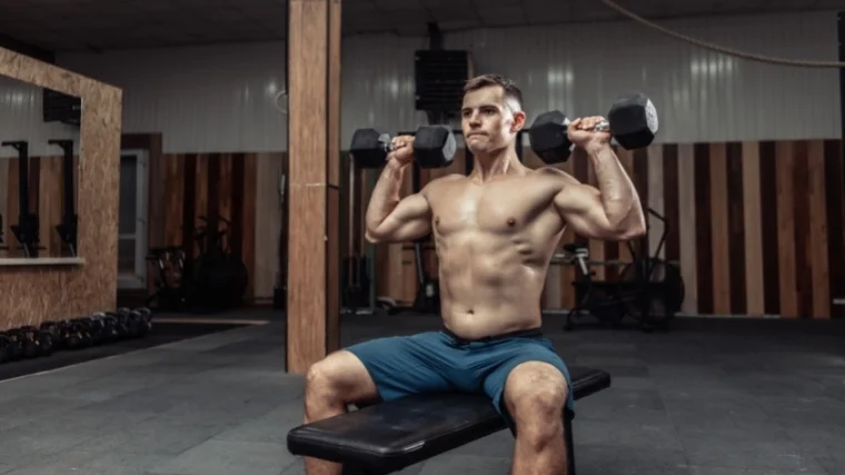 Man performing dumbbell overhead press