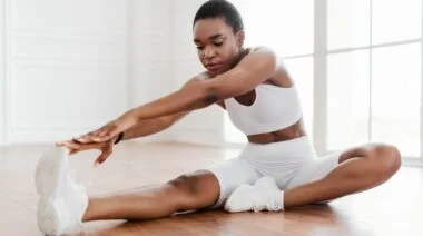 A person doing single-leg hamstring stretches.