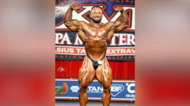 Bodybuilder Hunter Labrada hitting a front double biceps post on stage at the 2023 Tampa Pro.