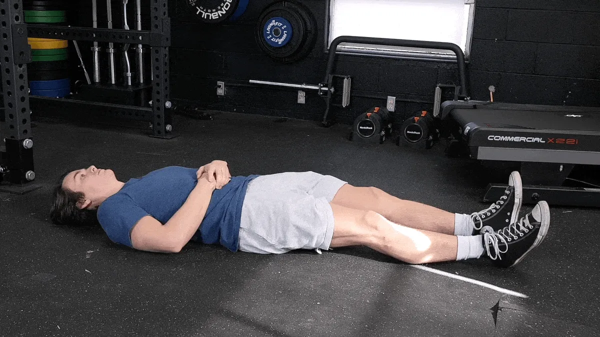 Jake is performing the knee to chest stretch.