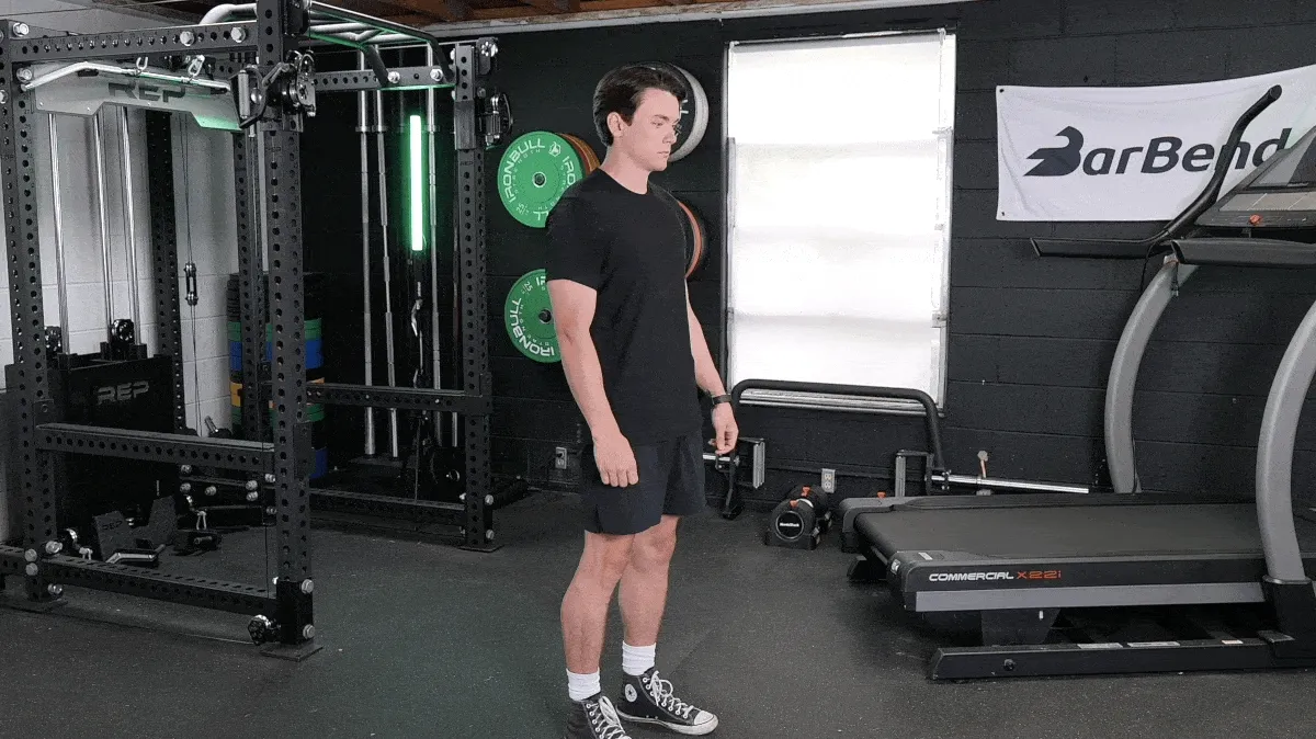 BarBend's Jake Herod performing the standing quad stretch.