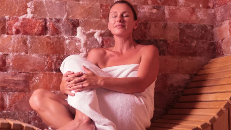 A person relaxing in the sauna. 