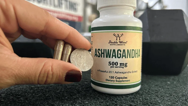 double wood ashwagandha capsules beside a quarter
