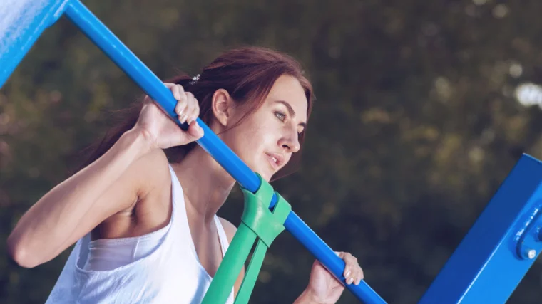 Woman performing a banded pull-up