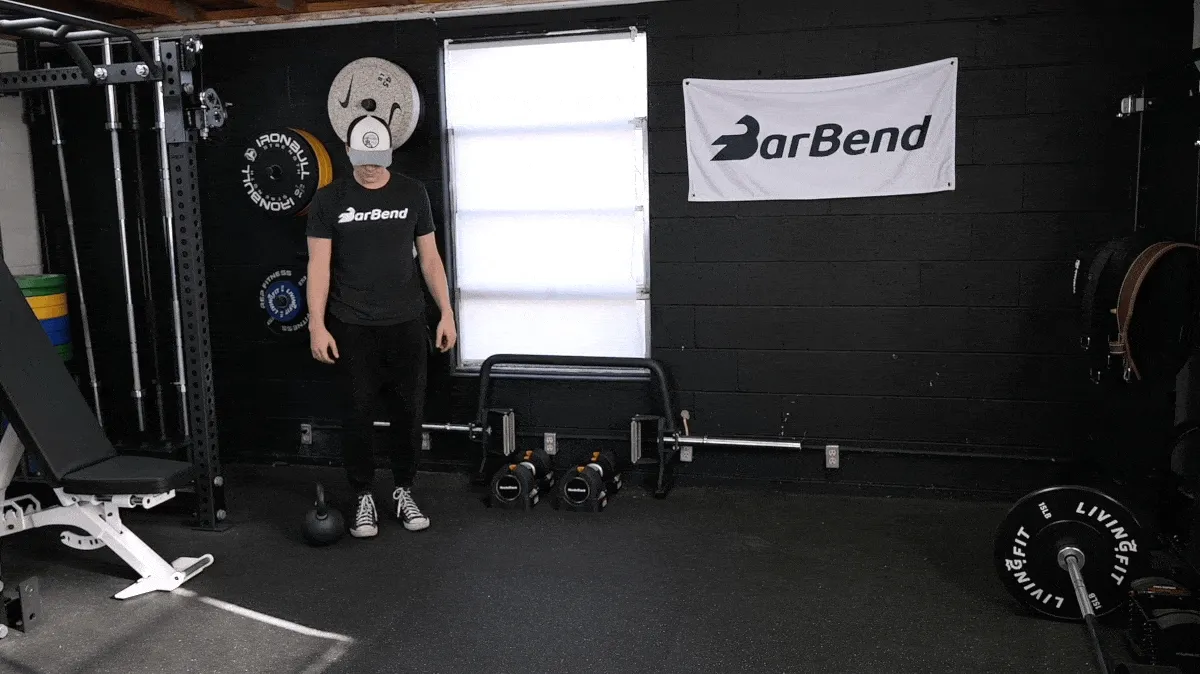 A person performing the suitcase carry exercise.
