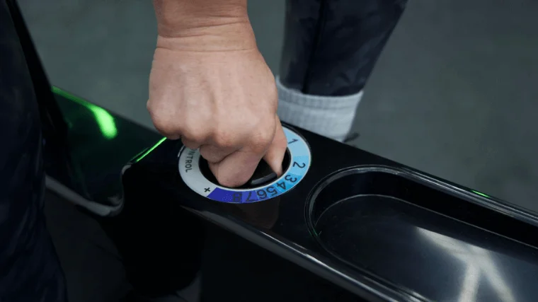 Our tester adjusting the resistance of the Sharper Image Space Saving Stationary Bike