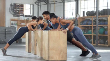 A set of people doing incline push ups
