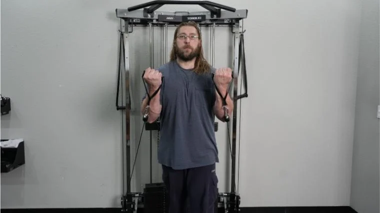 Our tester performing biceps curls on the Torque Fitness Anker 7.