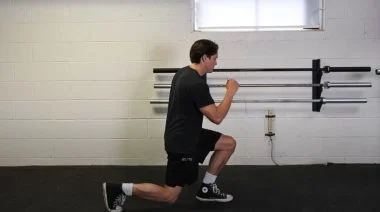 A person performing the walking lunge exercise.