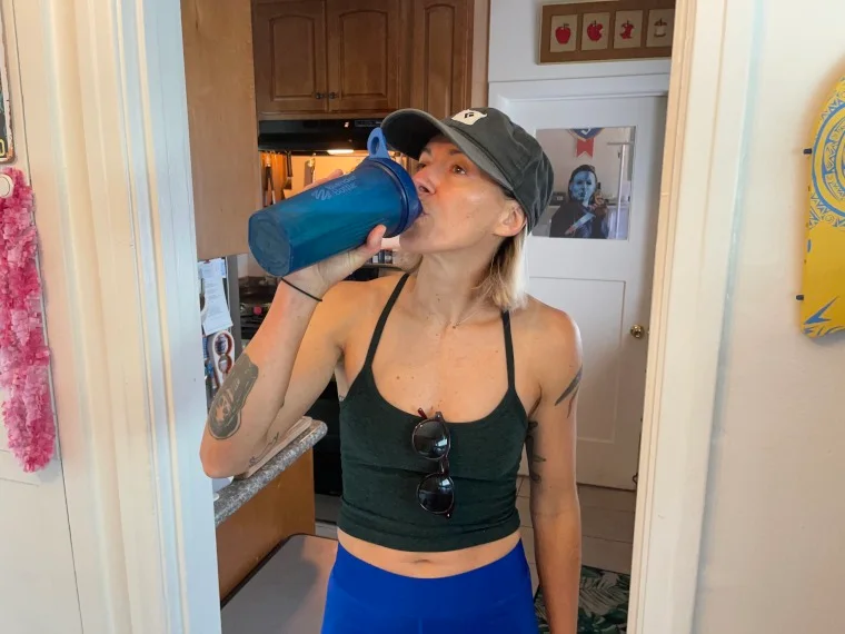 Our tester drinks Truvani Plant-Based Protein Powder from a blender bottle.