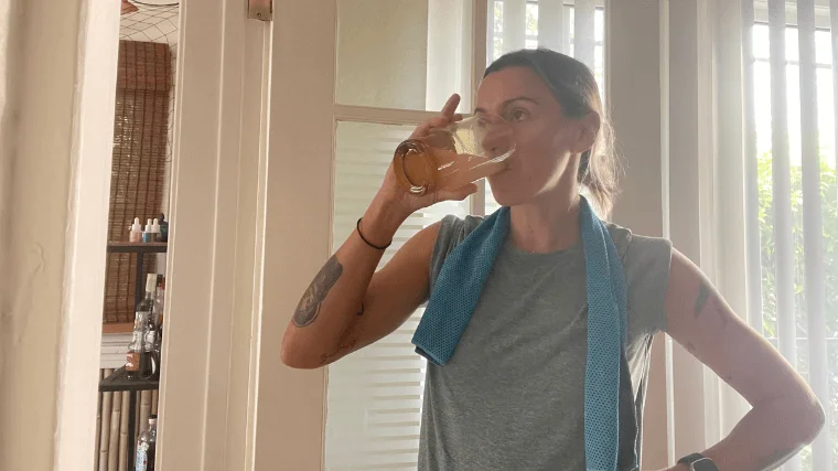 woman-drinks-nuun-sport-tablet-with-water Woman hydrates on a hot day with a Nuun Sport hydration tablet in some water