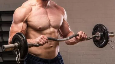 A closeup of a person doing a reverse bicep curl.