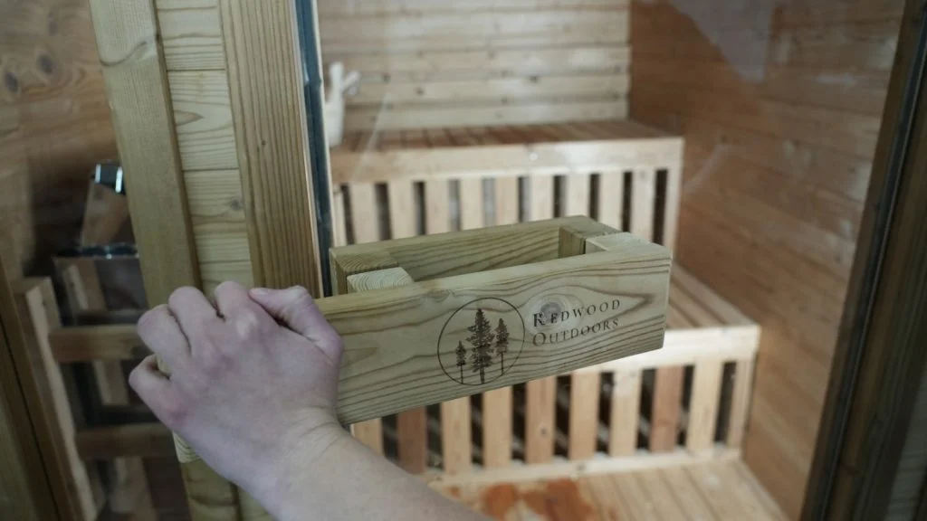 redwood outdoor sauna close up opening door with logo