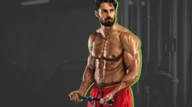 A person using a cable machine for one of the best biceps exercises.