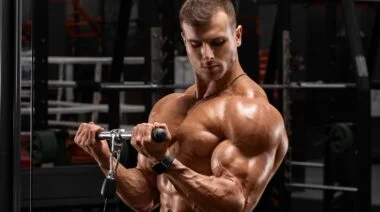 A person performing cable biceps curls.