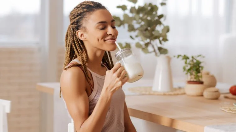 A person drinking a protein shake post workout.