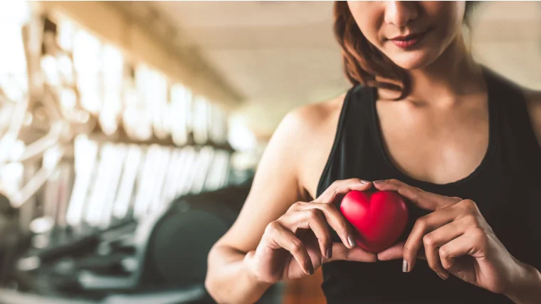 A person holding a red heart.