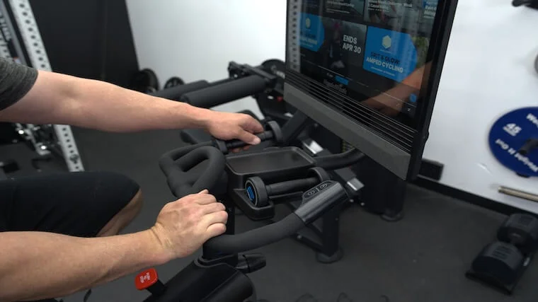 Our tester using the included dumbbells of the NordicTrack X24 Bike
