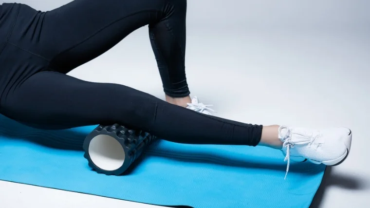 Woman rolling calves on foam roller