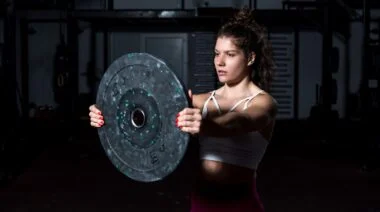 A person doing the front plate raise.