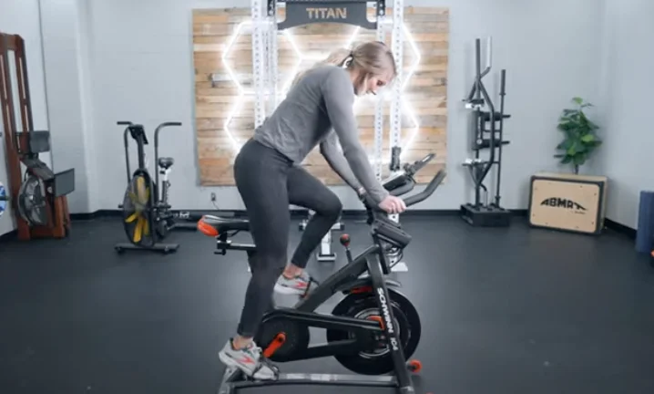 A person riding a Schwinn IC4 exercise bike