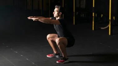 A person doing squats in the gym.