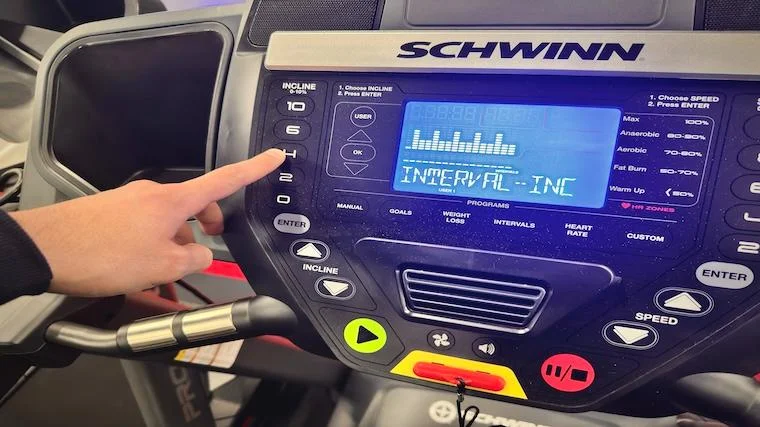 BarBend reviews writer Ben Emminger adjusting the incline on the Schwinn 810.