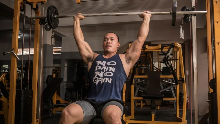 A person doing a shoulder press.
