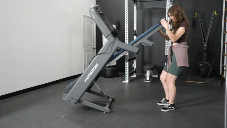 Kate unfolds a Horizon 7.4 AT Unfolding Treadmill.