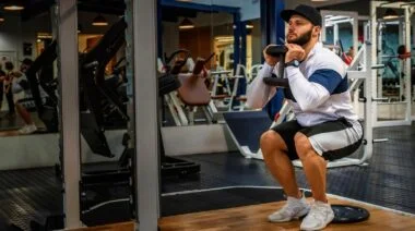 A person doing the Heels-Elevated Goblet Squat.