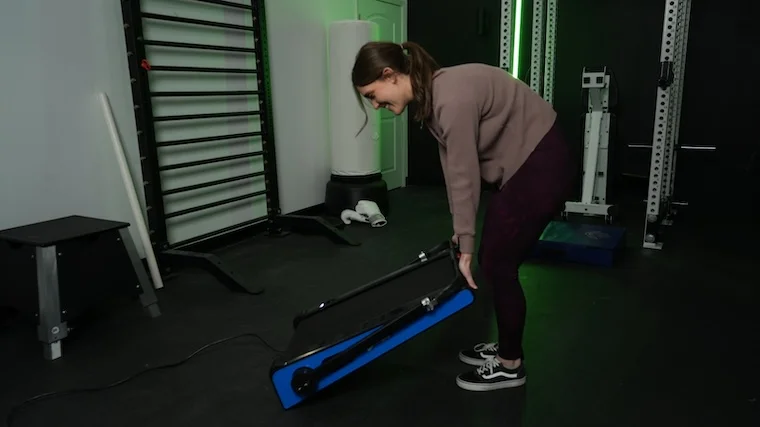 Our tester setting up the LifePro PacerMini for a workout
