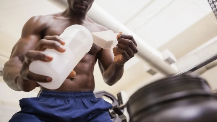 man making protein shake