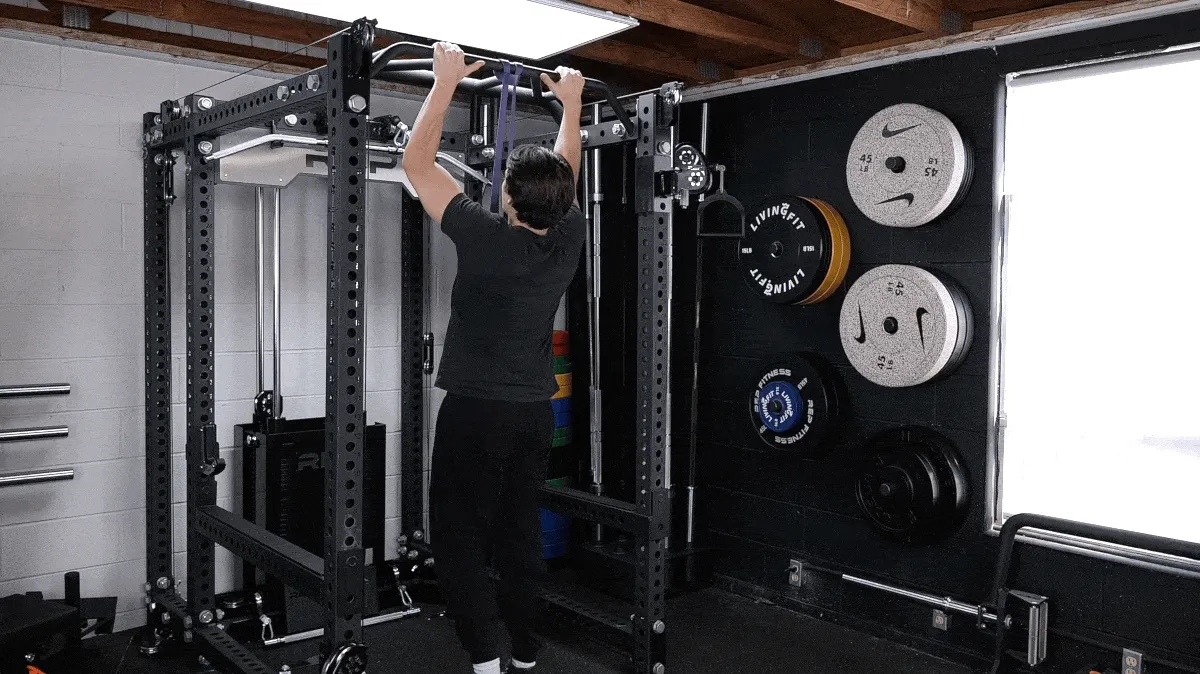 A person performing the band assisted pull-up exercise.