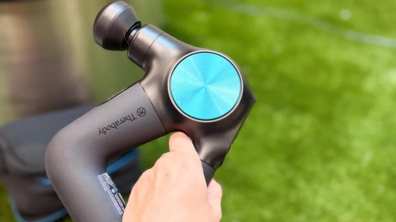 Our product tester holding the Therabody Theragun Pro Massage Gun