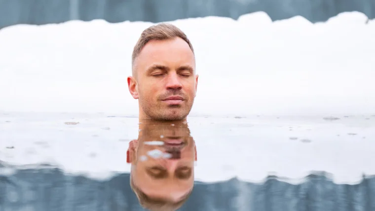 A person meditating in ice cold water.