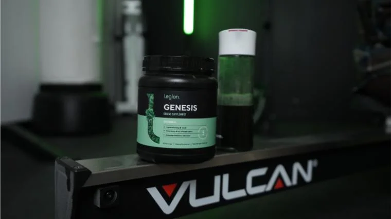 legion-genesis-superfood-greens-front-of-container-and-bottle Legion Genesis Greens in the BarBend gym.
