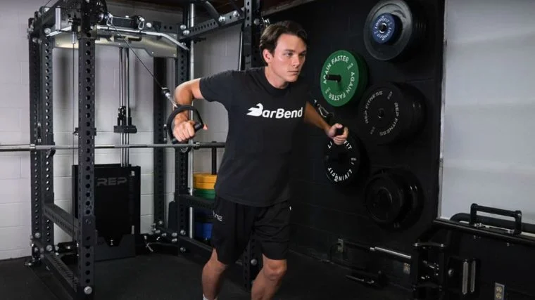 A person using a cable chest flye machine.