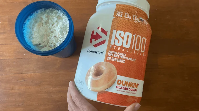 A person making a shake of Dymatize Iso 100 protein powder