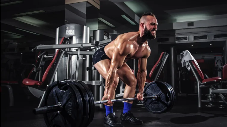 A person deadlifting a heavybarbell.