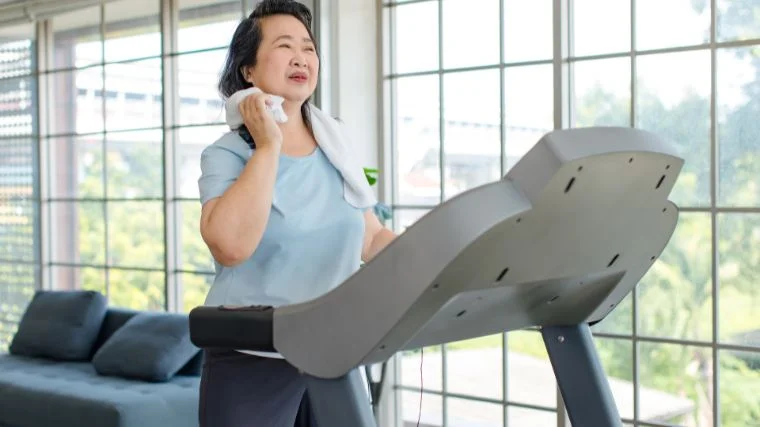 A person walking on the treadmill at home.