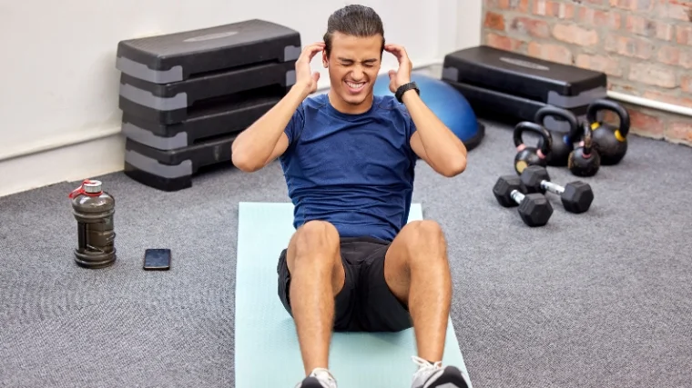 A person with headache, doing sit-ups.