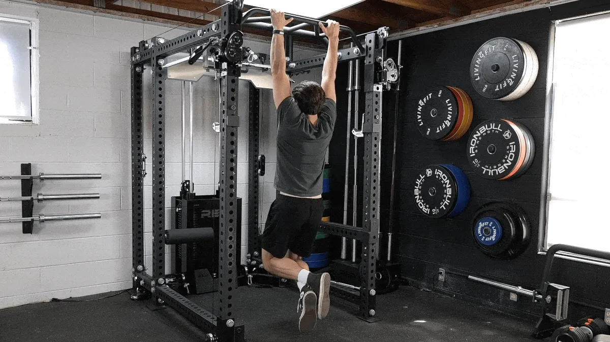 A person doing the dead hang exercise.