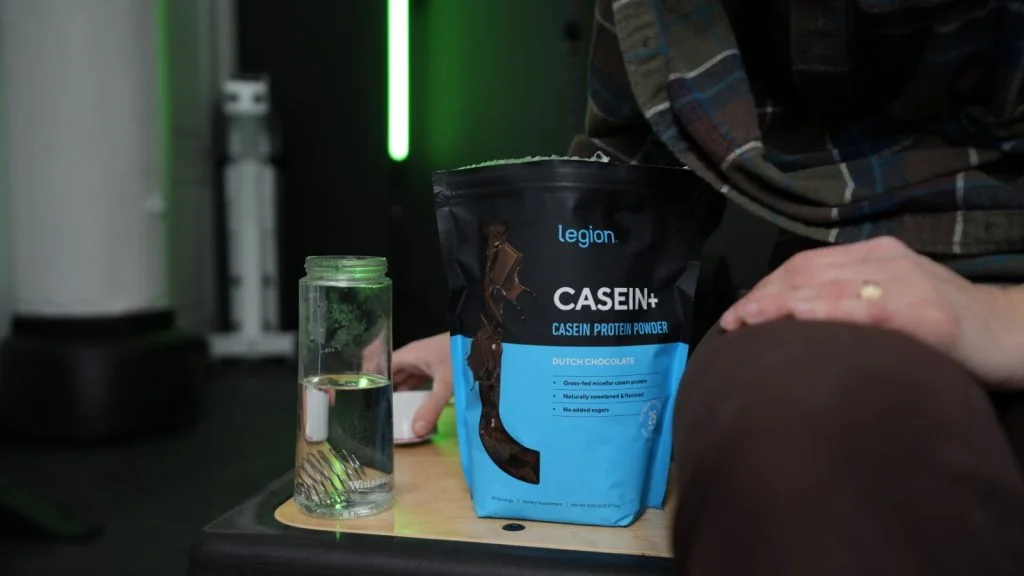 legion casien protein bag and bottle taking lid off bottle close up