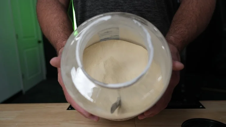 Our tester holding an open container of Naked Whey Protein
