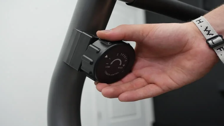 Our tester adjusting the resistance on the Sunny Health and Fitness Essential Recumbent Bike